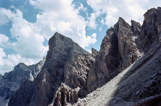 Striking view of Dolomite mountain peaks under a blue sky in Trentino-Alto Adige, Italy.