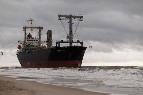 Free A large cargo ship navigating through rough seas with overcast skies near Kaliningrad's coastline. Stock Photo