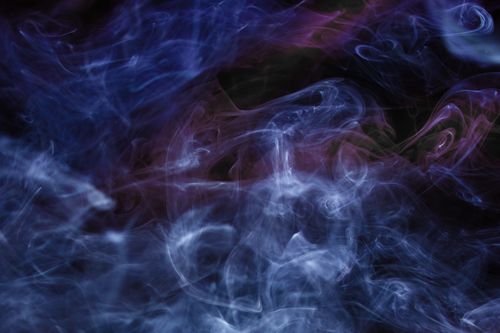 Free A captivating abstract art piece featuring dynamic, colorful smoke swirls against a dark background. Stock Photo