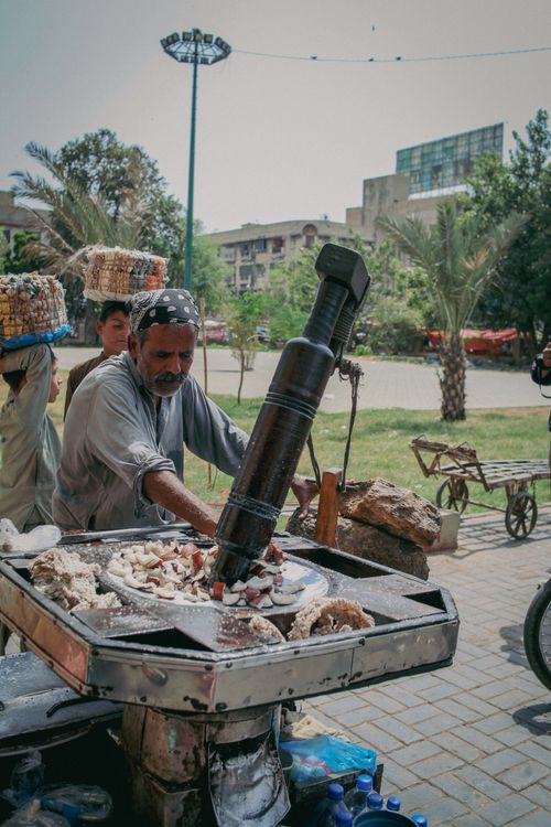 Free A man extracting coconut oil using traditional methods in Karachi, Pakistan. Stock Photo