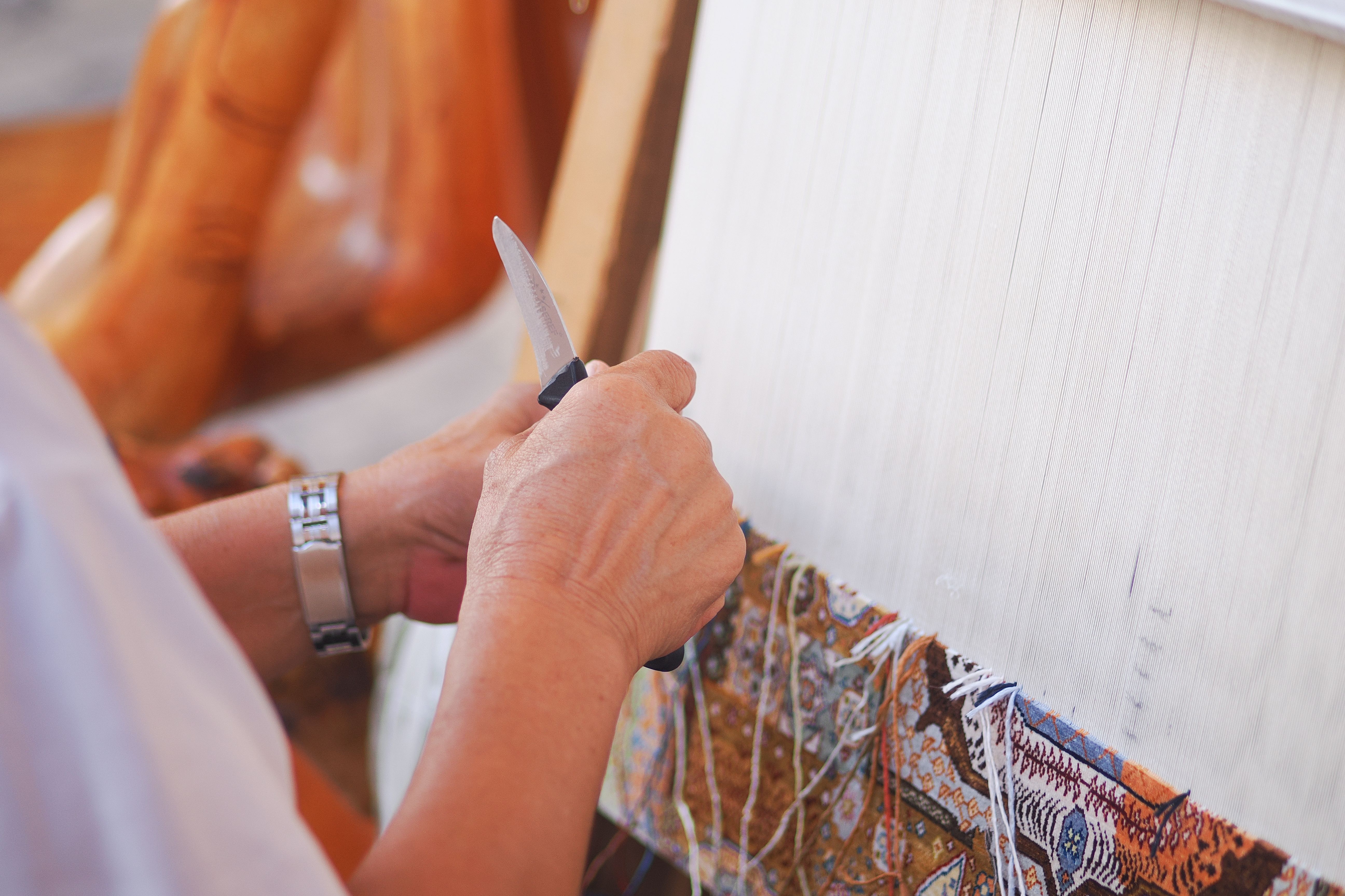 Hands Weaving Intricate Carpet Design · Free Stock Photo