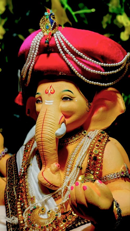 Free Brightly decorated Ganesh idol with traditional attire and vibrant colors from Shrivardhan, India. Stock Photo