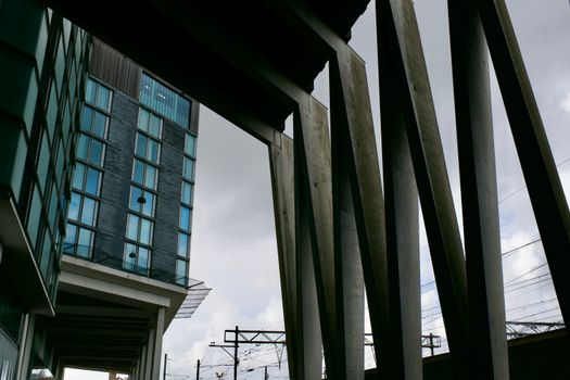 Striking urban architecture showcasing geometric design elements against a cloudy sky.