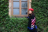 Woman Wearing Red Beret Hat Near Brown Window