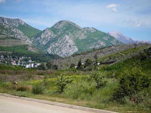 Free Breathtaking landscape of Montenegro featuring lush green mountains and a quaint village. Stock Photo