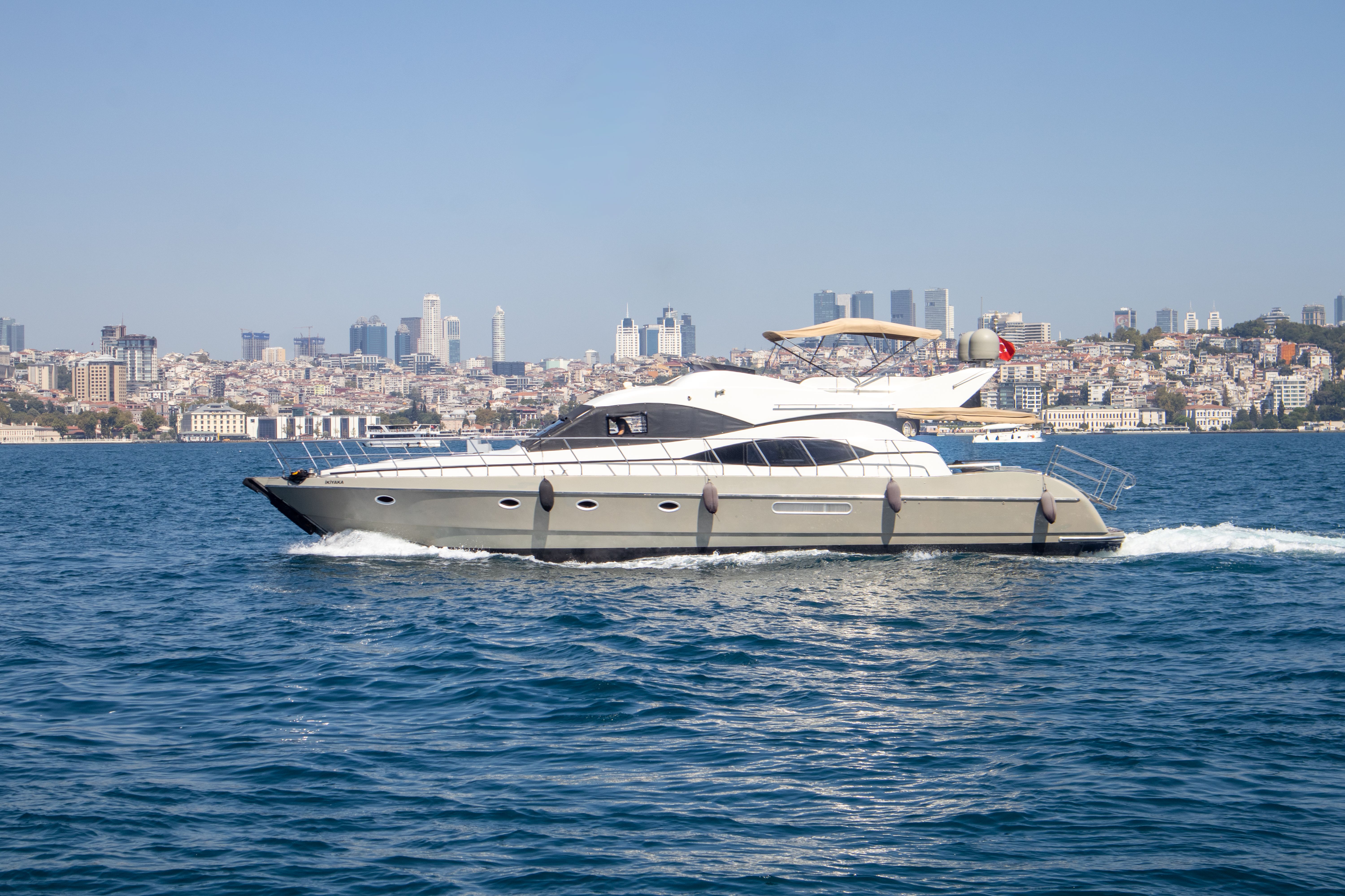 Luxury yacht cruising on the Bosphorus with Istanbul skyline