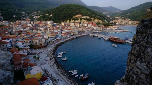 Free Aerial view of a vibrant coastal town with colorful houses and boats in a serene bay. Stock Photo