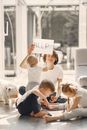 Tired mother kidding while sitting with children