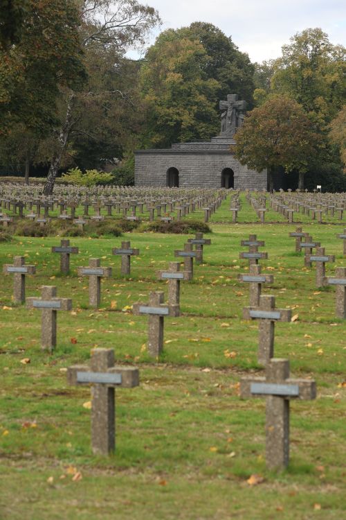 Free Historic war cemetery with rows of crosses in Lommel, Belgium, surrounded by lush trees. Stock Photo