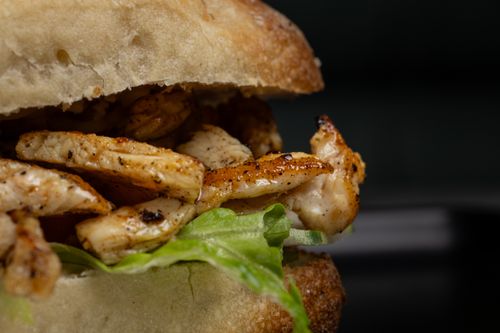 Free Macro view of a delicious grilled chicken sandwich with lettuce. Stock Photo