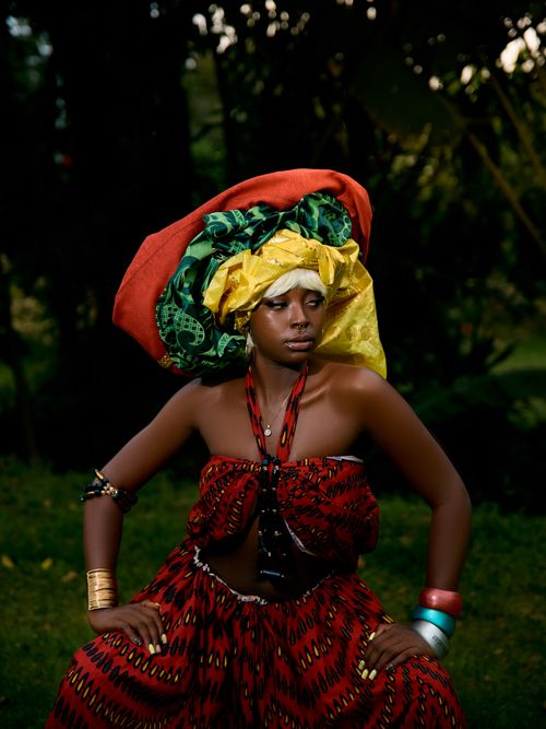 Free Portrait of a woman in vibrant traditional African dress outdoors. Stock Photo