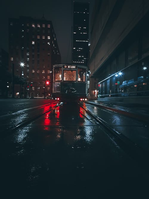 Tram Line on Road during Night Time