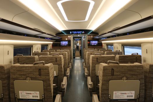 Modern interior of a high-speed train in Beijing, showcasing comfort and technology.