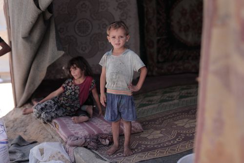 Free Two children in a refugee camp, highlighting resilience and environment. Stock Photo