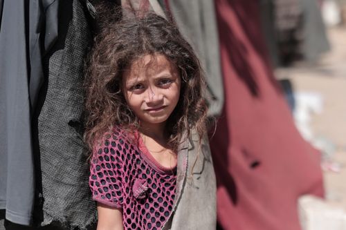 Free A young girl stands outdoors, conveying resilience amidst adversity. Stock Photo