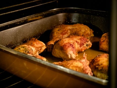 Deliciously seasoned chicken legs roasting in an oven for a home-cooked meal.
