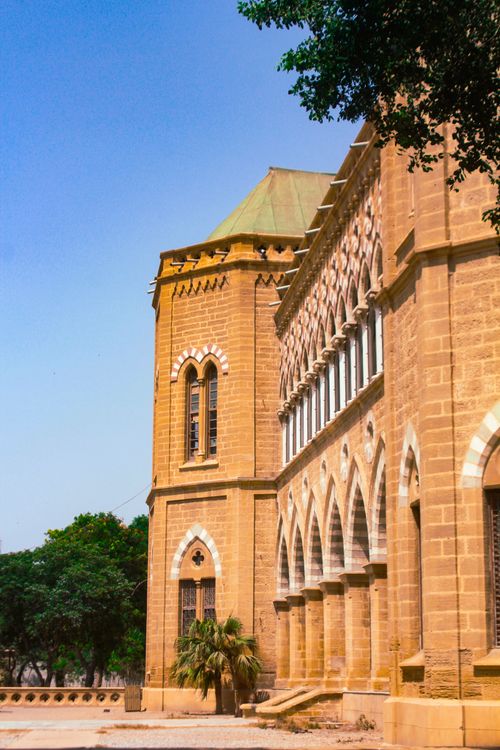 Free A captivating view of a Gothic Revival building illuminated by daylight, showcasing its intricate design. Stock Photo