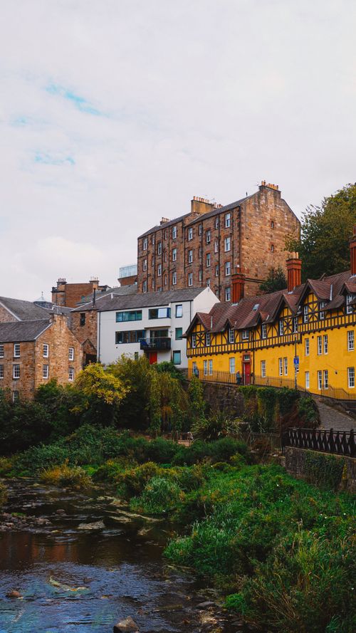 Free Charming view of colorful historic buildings in Dean Village, Edinburgh along the Water of Leith. Stock Photo