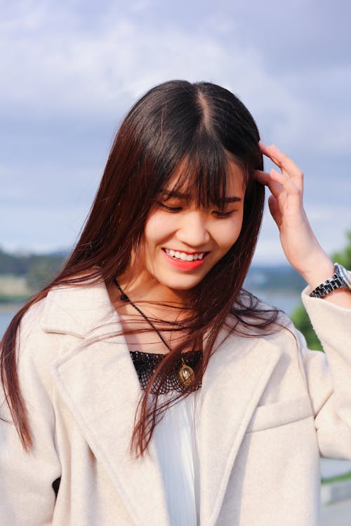 Woman in White Coat Smiling