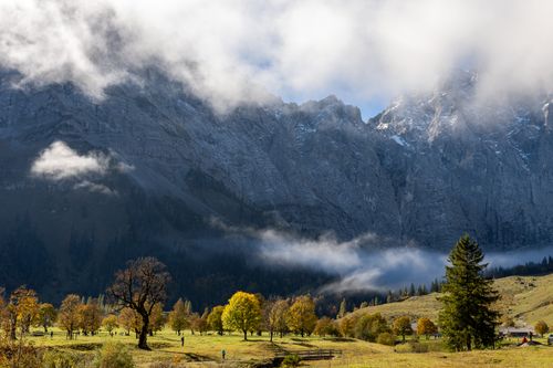 Free Beautiful autumn scenery with mountains and misty clouds in a serene landscape. Stock Photo