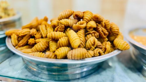 Free Close-up of crunchy Indian snacks Namak Pare in a metal dish, perfect for munching. Stock Photo