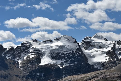 Free Breathtaking view of the snow-capped Cordillera Blanca mountains under a clear blue sky. Stock Photo