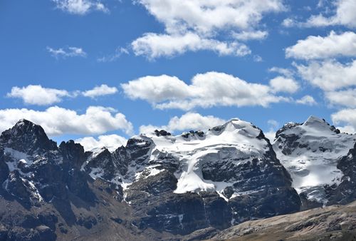 Free Majestic snow-covered mountains under a blue sky in Peru's Cordillera Blanca. Stock Photo
