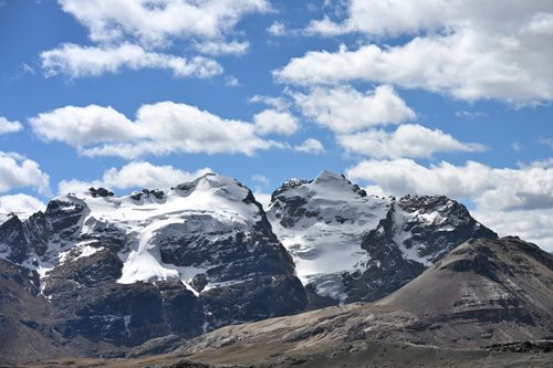 Free Breathtaking view of snow-covered mountains against a vibrant blue sky in Cordillera Blanca, Peru. Stock Photo