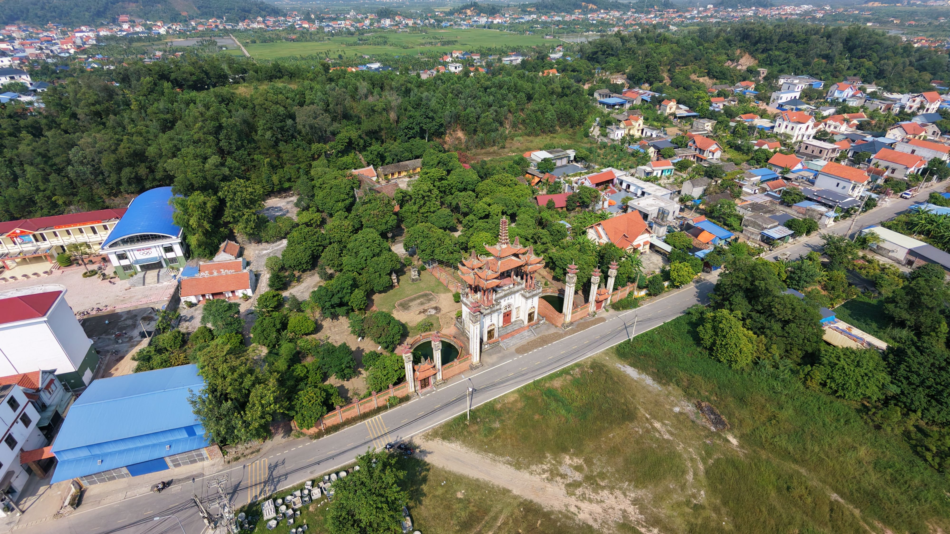 Aerial shot of a Vietnamese temple and surrounding landscape in Hai Phong, Vietnam, during the day. — lounges at Hai Phong Airport