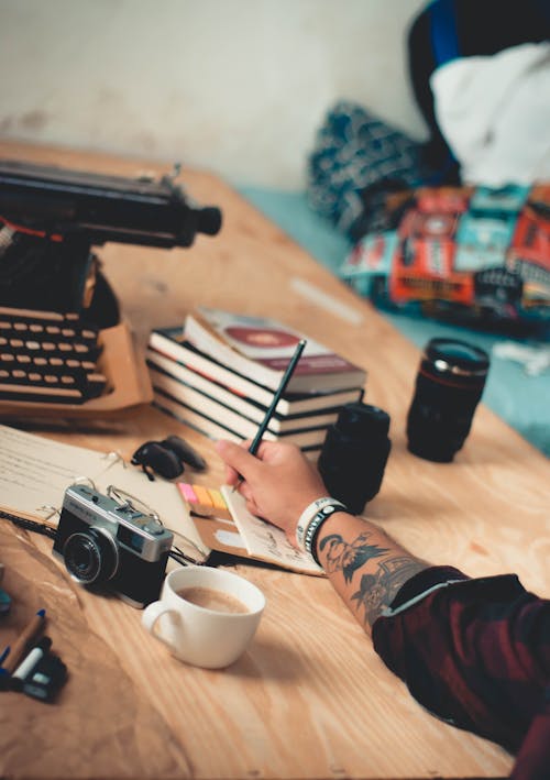 Free Man Writing on His Notebook Stock Photo