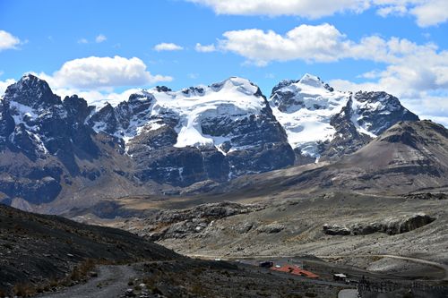Free Explore the stunning snow-capped peaks of the Cordillera Blanca in Peru under a vibrant blue sky. Stock Photo