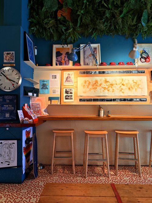 Free Trendy Barcelona café interior with art, stools, and vibrant decor. Stock Photo
