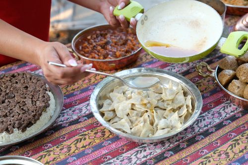 Free A vibrant display of traditional Anatolian dishes from Sivas, featuring dumplings and rice. Stock Photo