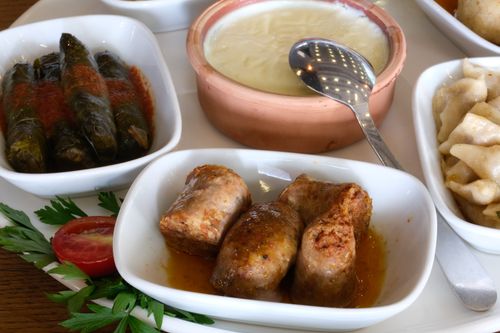 Free A delicious assortment of Turkish meze featuring sucuk, dolma, and manti, perfect for cultural culinary exploration. Stock Photo