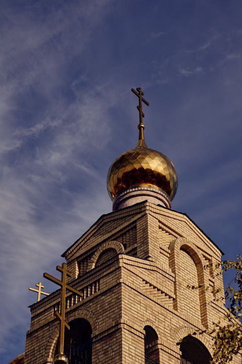 Free Beautiful view of an Orthodox church's golden dome with crosses against a blue sky. Stock Photo