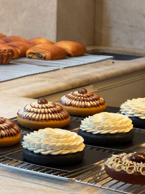 Free Deliciously decorated pastries on display at a Parisian bakery showcasing intricate designs and textures. Stock Photo