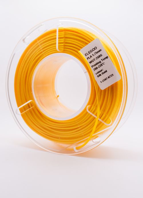 Free Close up of a spool of yellow PLA filament for 3D printing, showcasing details. Stock Photo