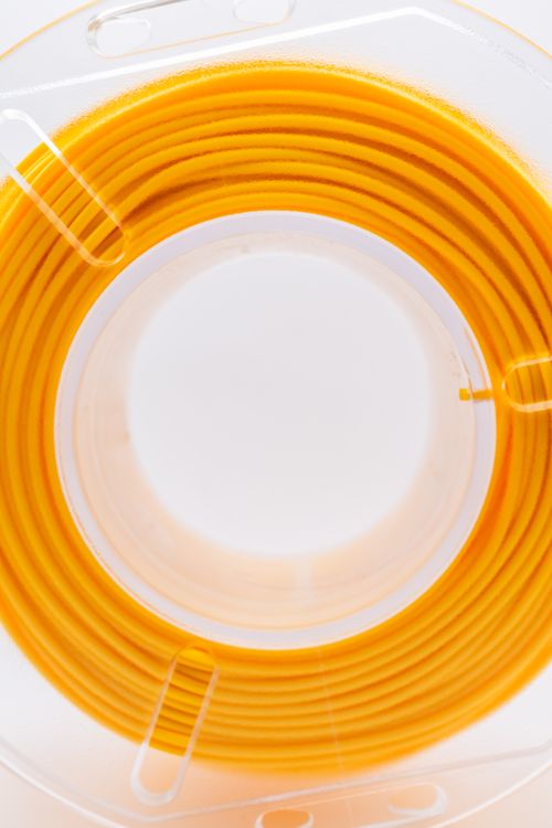 Free A detailed view of a yellow cable spool with a focus on its circular arrangement and vibrant color. Stock Photo