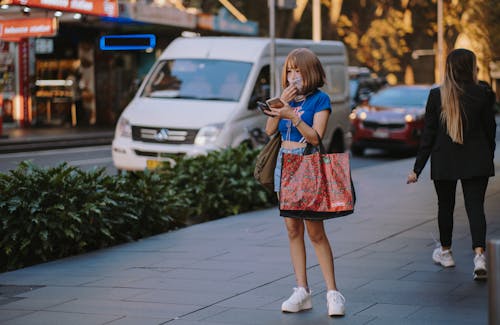 Woman Holding Two Smartphones Busy Texting