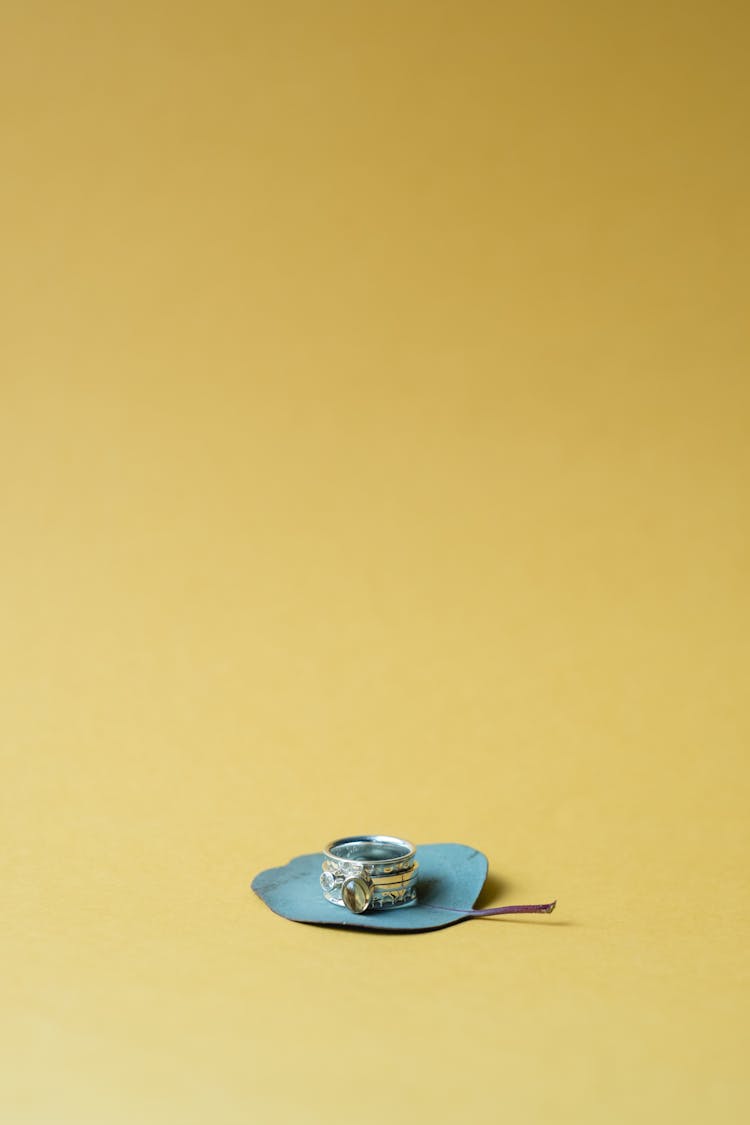 Silver Diamond Ring On Yellow Surface