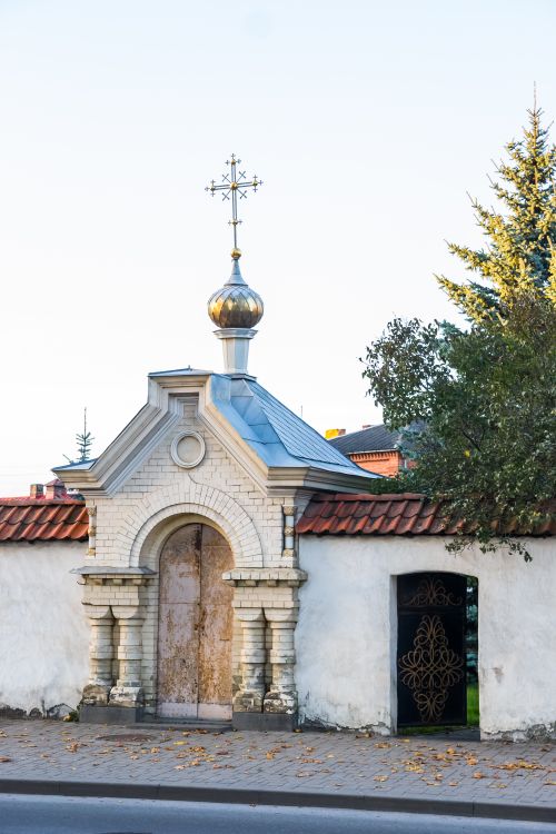 Free Orthodox church entrance featuring a golden dome and ornate cross, under clear sky. Stock Photo