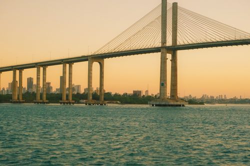 Free Captivating sunset over Newton Navarro Bridge in Natal, Brazil with cityscape in the background. Stock Photo