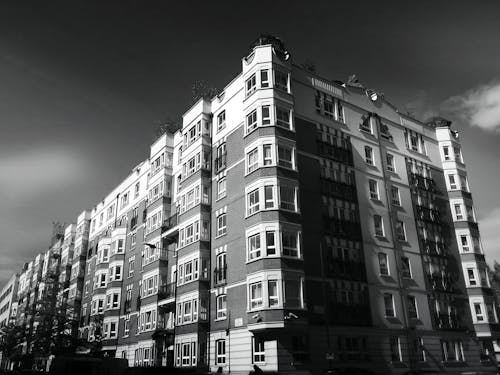 Grayscale Photo of Building Under Clear Day Sky