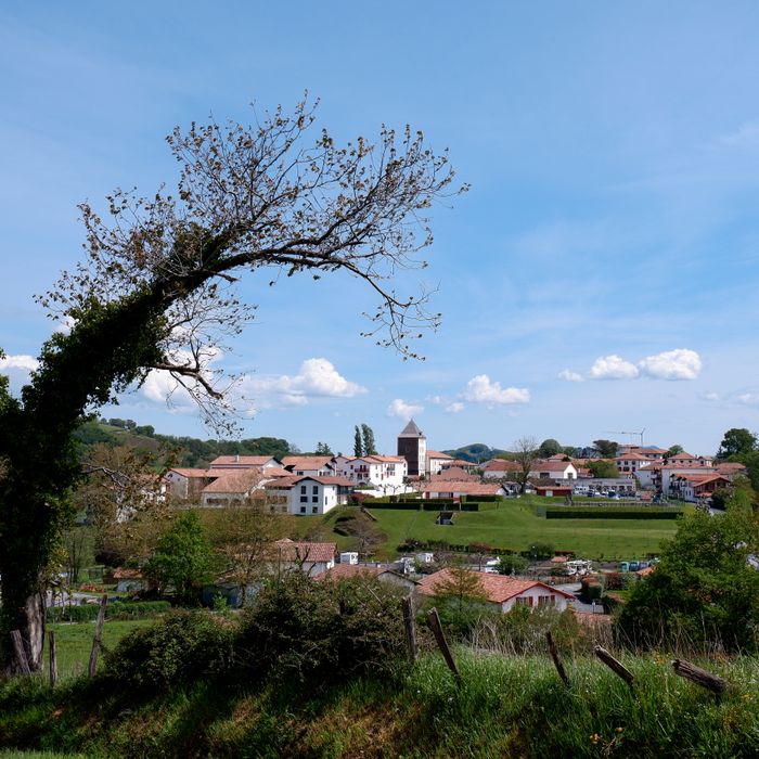 Picturesque village in Sare, France with rolling hills and traditional Basque architecture.