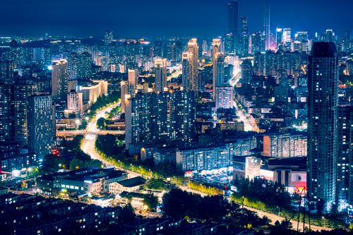 Free An illuminated cityscape of Jilin Province, China at night, showcasing tall buildings and urban lights. Stock Photo