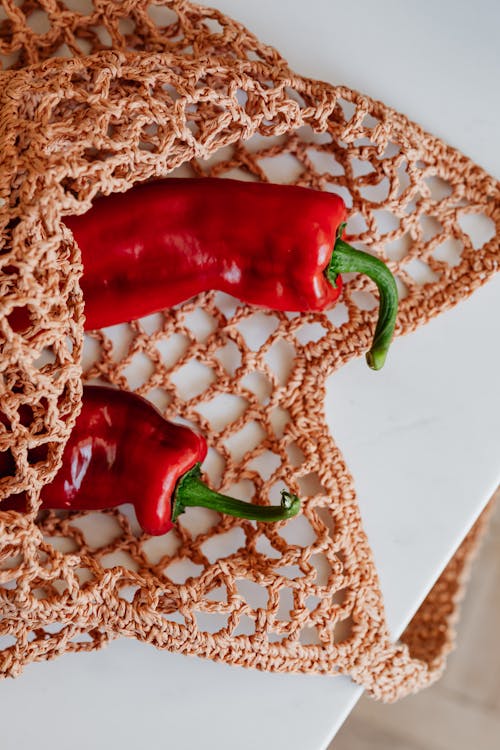 Free Red chili peppers in food net on table Stock Photo