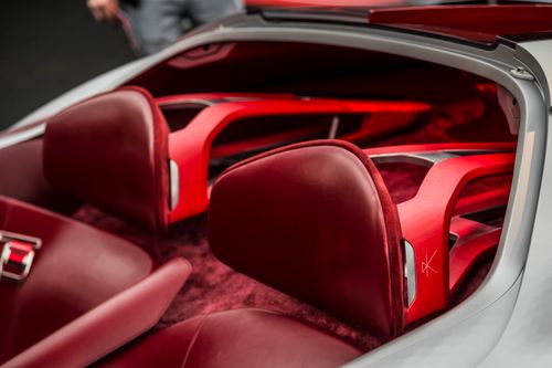 Free Close-up of a luxury car interior with elegant red leather seats and modern design. Stock Photo