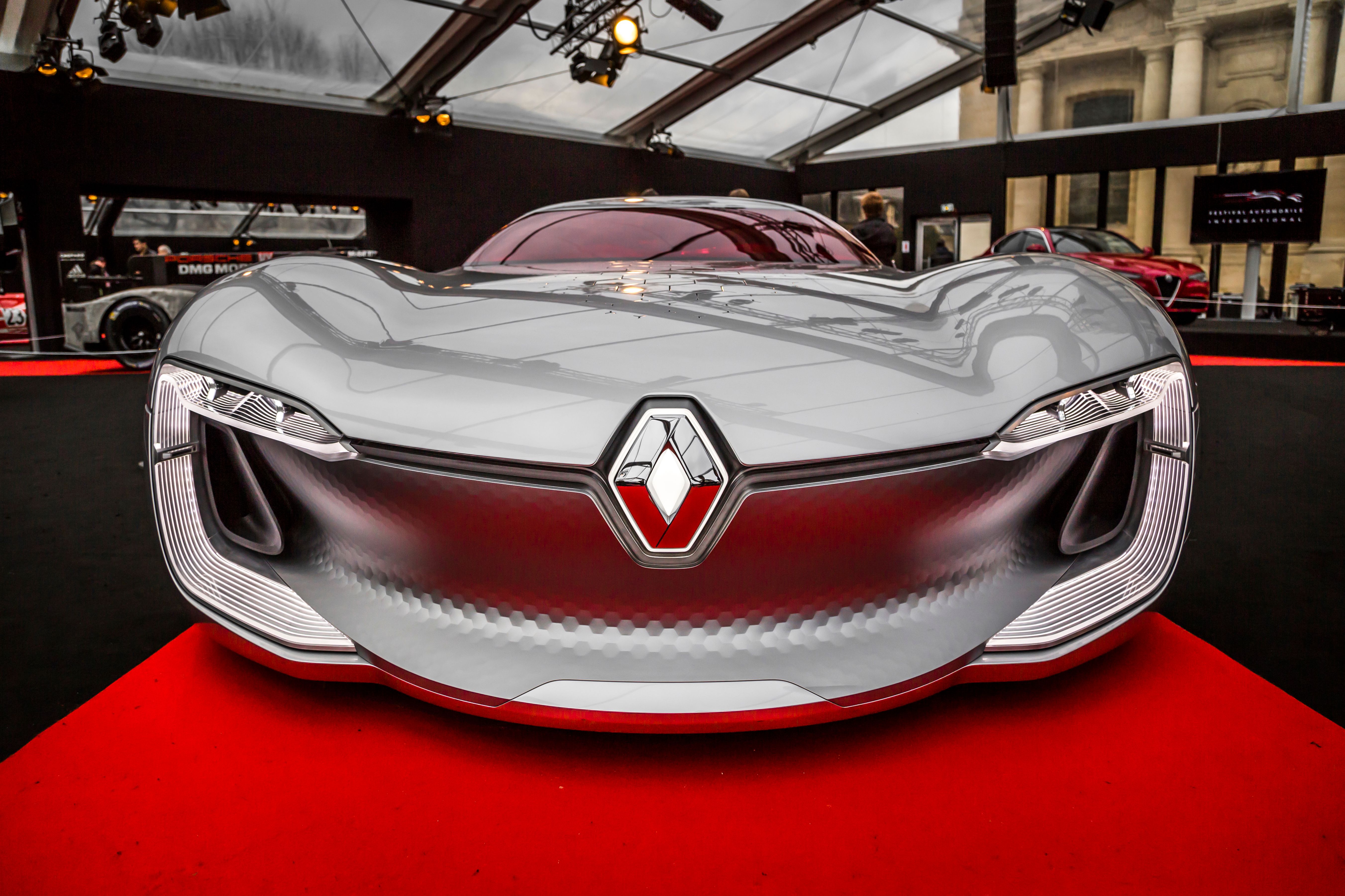 Silver concept car with sleek design at an automotive event