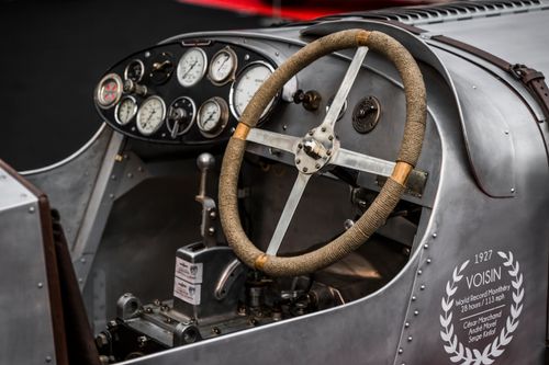 Free Close-up of the dashboard and steering wheel of a classic Voisin race car, showcasing detailed instrumentation. Stock Photo