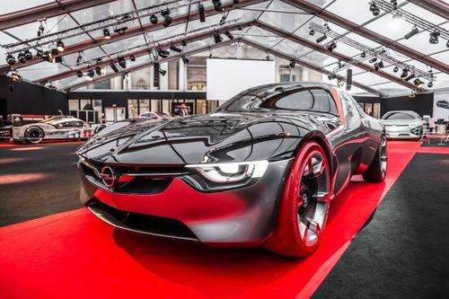 Free Modern concept car on display at a prestigious auto show under an elegant glass roof. Stock Photo